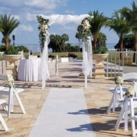Arch with draping and flowers and chair flowers